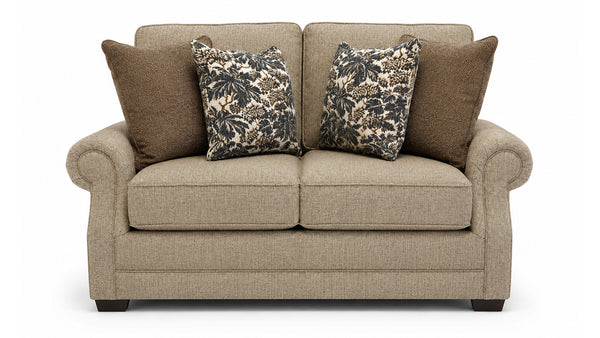Beige sofa with patterned and solid color cushions on a white background