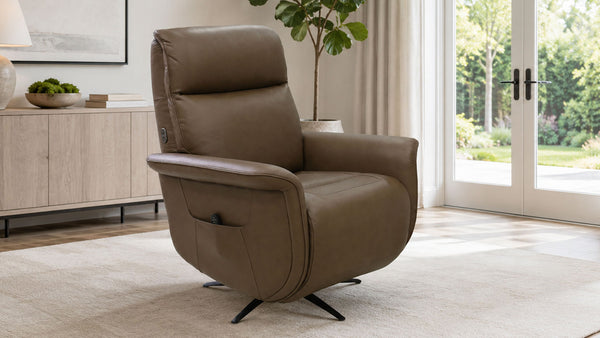 A brown upholstered recliner chair with a swivel base, shown in a bright, modern living room with large windows and a sideboard.