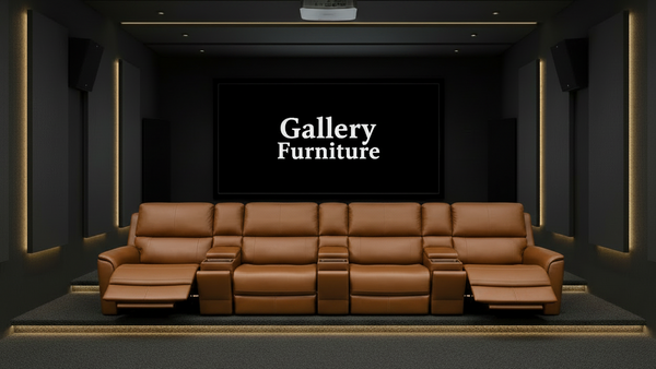 Brown leather sofa in a dark room with 'Gallery Furniture' branding.