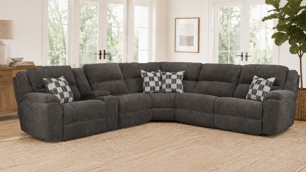 Gray sectional sofa with checkered pillows in a living room setting.