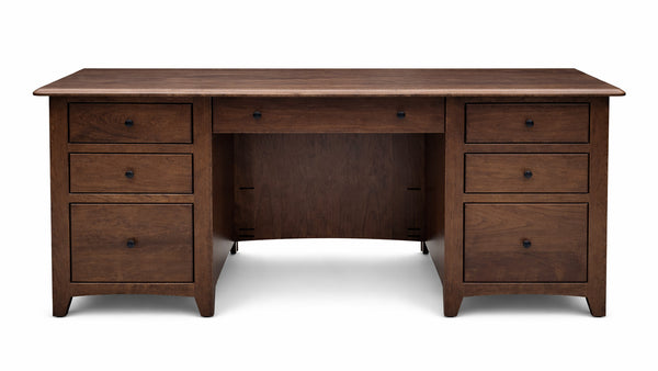 Wooden desk with multiple drawers on a white background