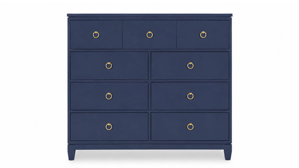 Navy blue dresser with gold knobs on a white background