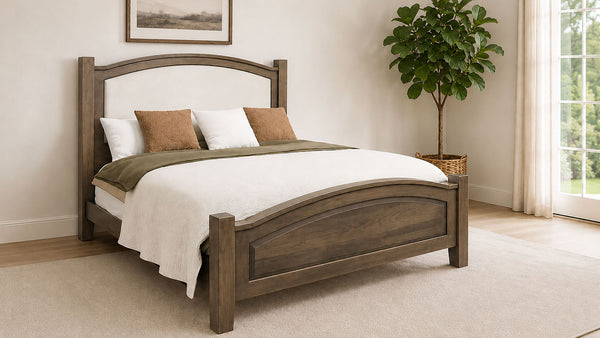 Wooden bed with white bedding in a room with a plant and window.