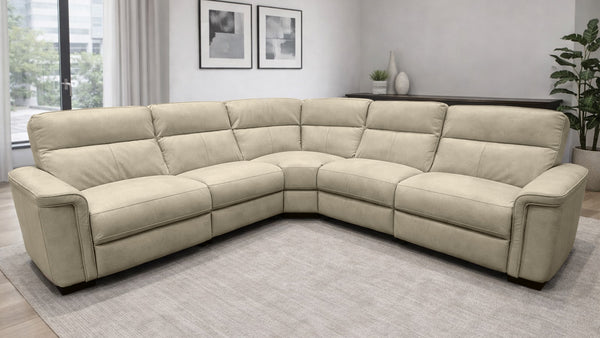 Beige sectional sofa in a living room setting with decor elements.