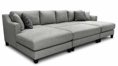 Gray sectional sofa with patterned cushions on a white background