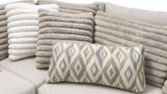 Patterned pillow on a textured sofa with stacked cushions in the background