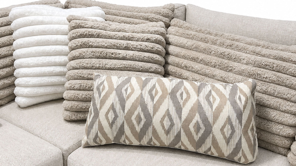 Patterned pillow on a textured sofa with stacked cushions in the background