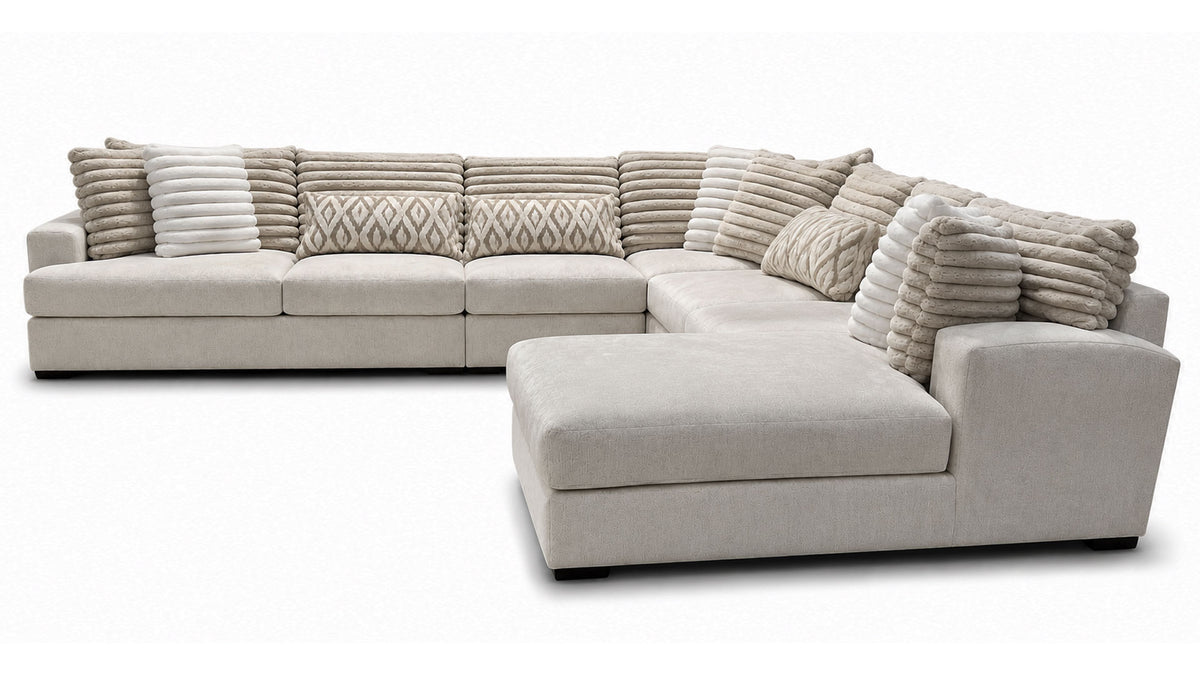 Beige sectional sofa with patterned cushions on a white background