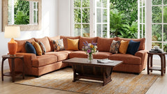 Brown sectional sofa in a living room with a coffee table and decorative items.
