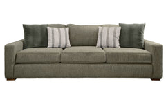 Green sofa with patterned pillows on a white background