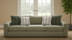 Green sofa with decorative pillows in a living room setting