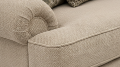 Close-up of a beige textured sofa with cushions