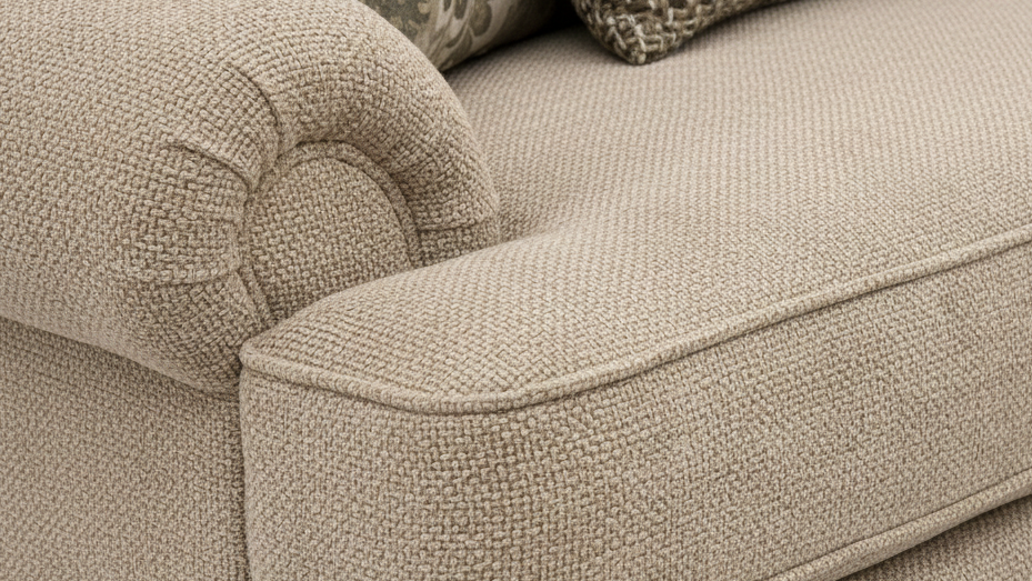 Close-up of a beige textured sofa with cushions