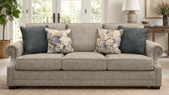 Gray sofa with patterned cushions in a living room setting