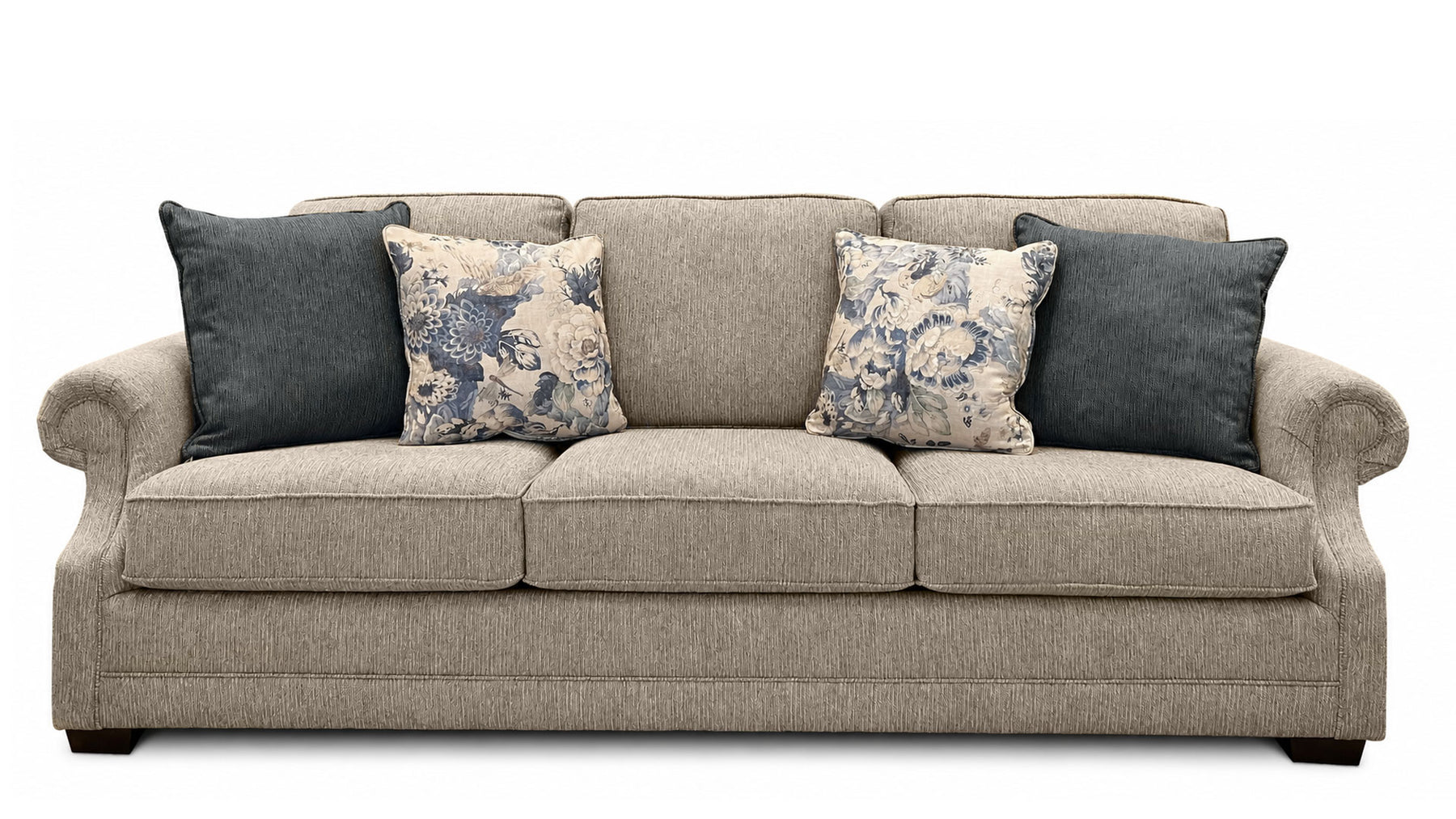 Gray sofa with floral and solid blue pillows on a white background