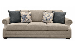 Gray sofa with floral and solid blue pillows on a white background