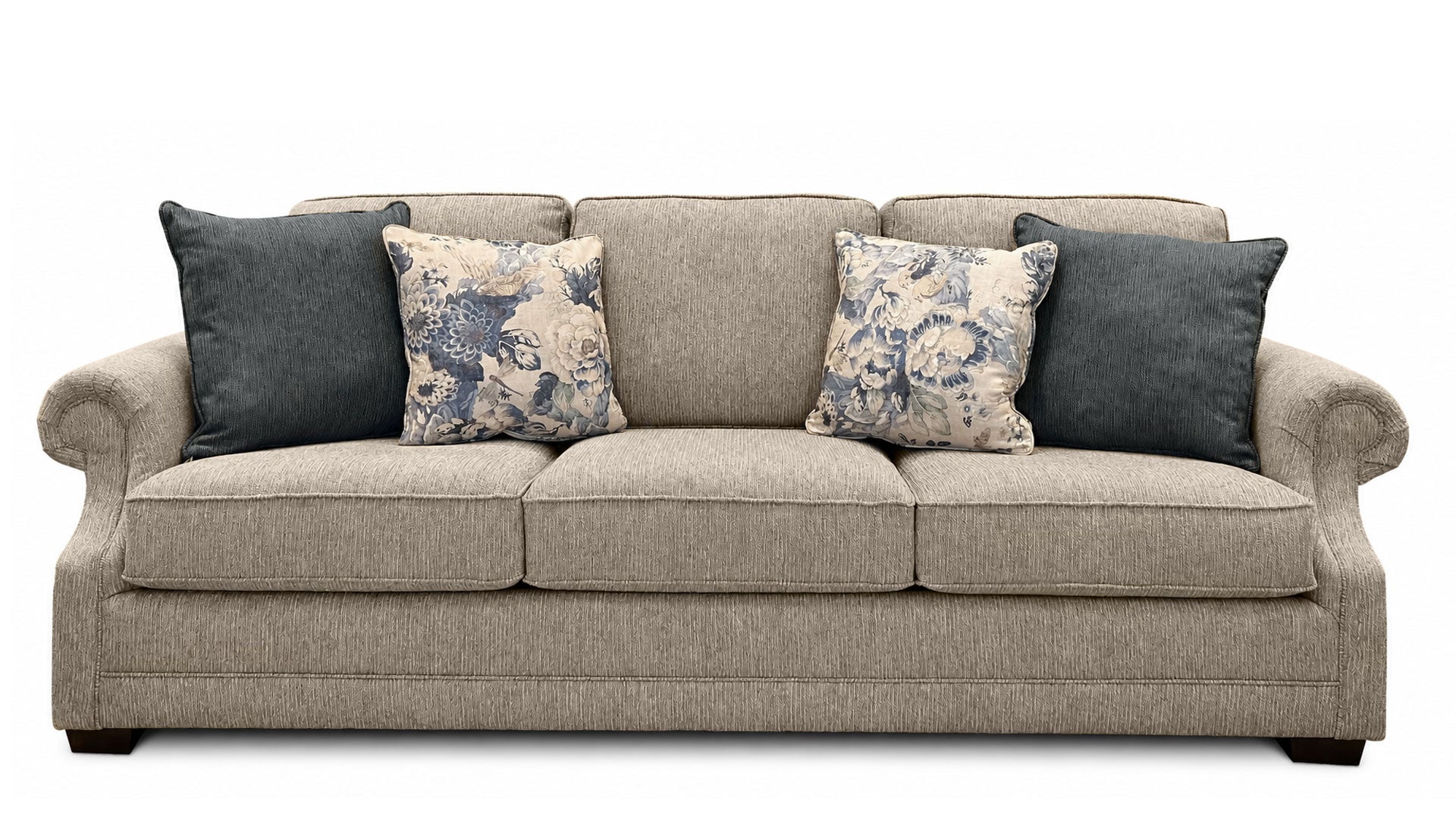 Gray sofa with floral and solid blue pillows on a white background