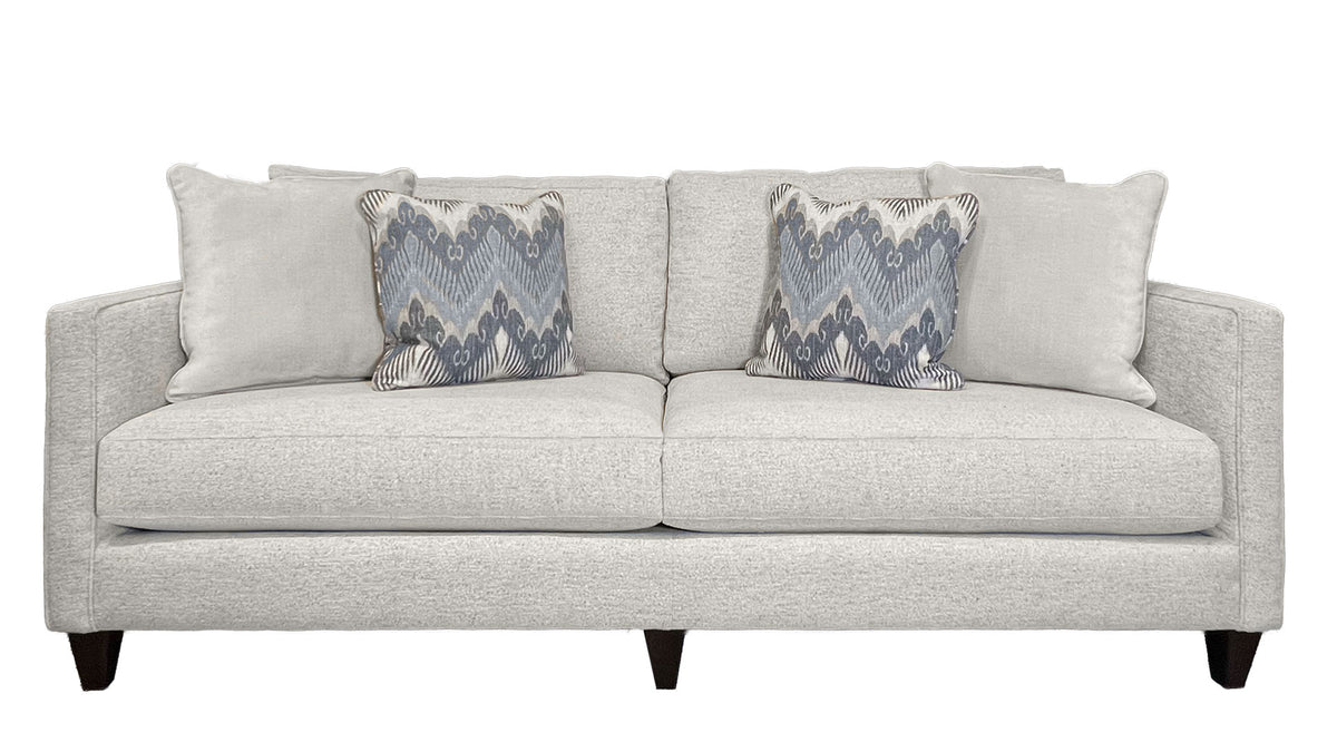 Gray sofa with patterned cushions on a white background