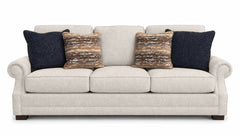 Beige sofa with decorative pillows on a white background