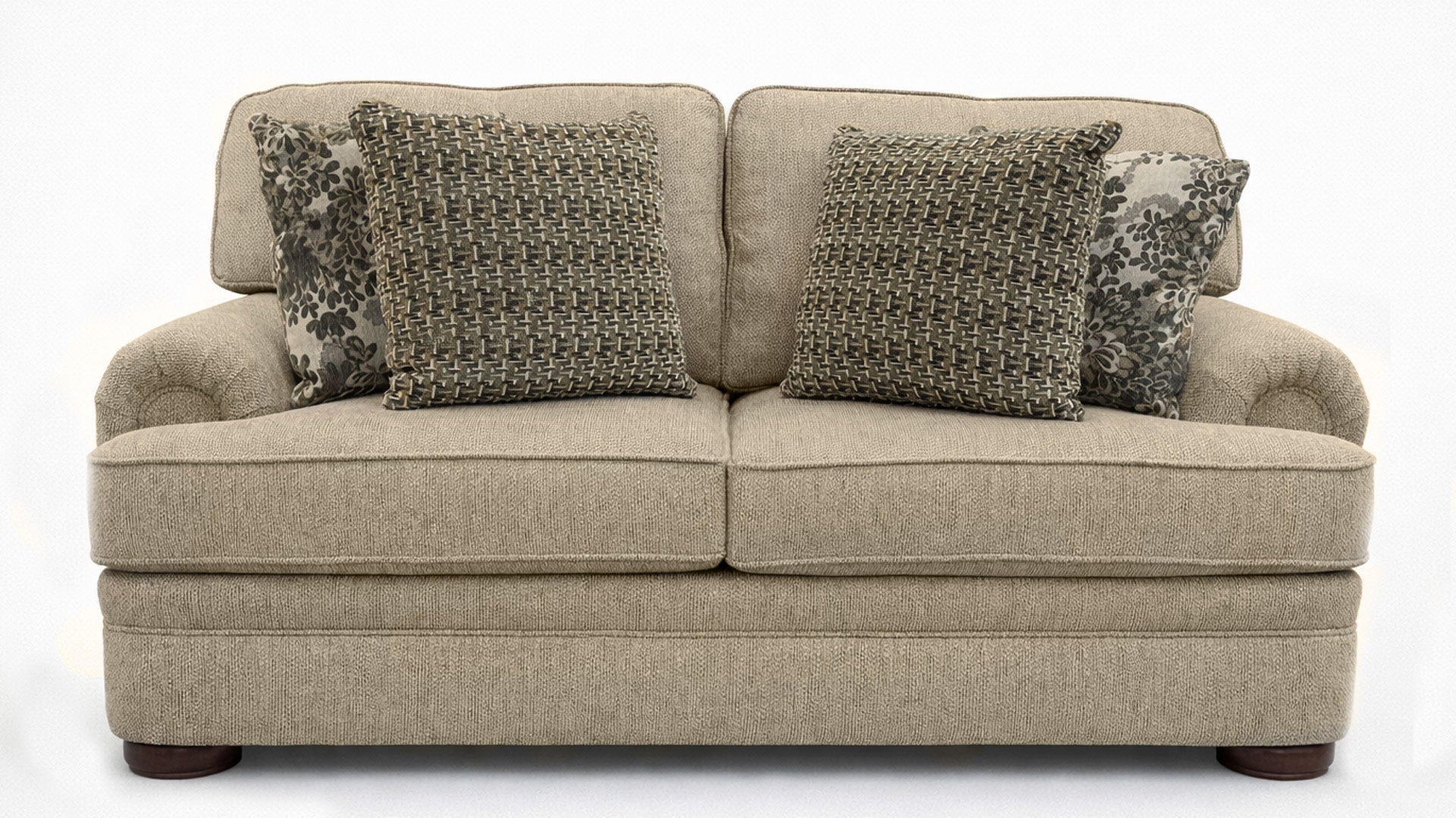 Beige sofa with patterned cushions on a white background