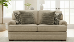 Beige sofa with patterned cushions in a bright living room.