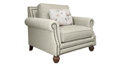 Beige armchair with a floral pillow on a white background