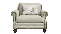 Light gray armchair with a floral pillow on a white background