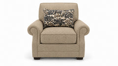 Beige armchair with a floral-patterned pillow on a white background