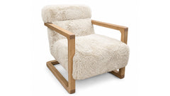 A modern accent chair featuring a thick, fluffy cream-colored sheepskin or faux fur upholstery with a natural light brown wooden frame, shown against a plain white background.