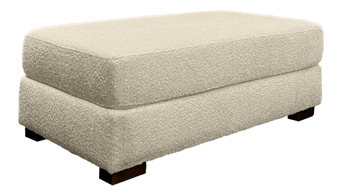 Beige ottoman with a textured surface on a white background