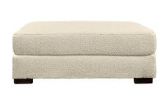 Beige ottoman with a textured surface on a white background