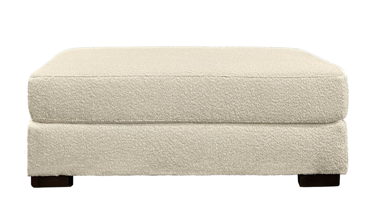 Beige ottoman with a textured surface on a white background