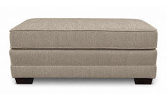 Beige ottoman with a textured surface on a white background