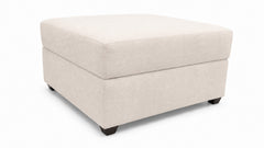A square upholstered ottoman with a lift-top design, finished in a light beige textured fabric and supported by four small dark legs, shown on a plain white background.