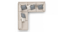 An L-shaped sectional sofa in light beige fabric, styled with four throw pillows (three gray plaid and one cream), shown from a top-down perspective on a white background.