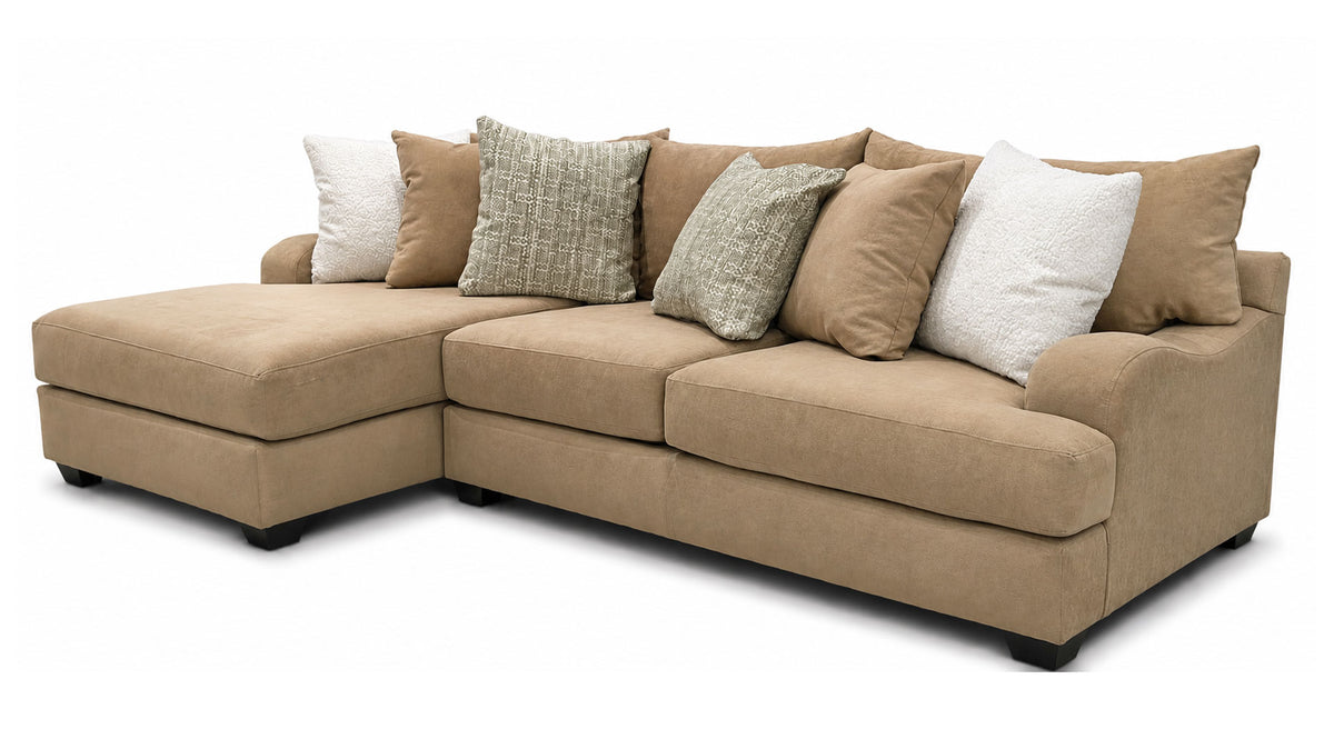A beige fabric sectional sofa with a left-facing chaise lounge, styled with multiple throw pillows in beige, textured gray, and white, shown against a plain white background.