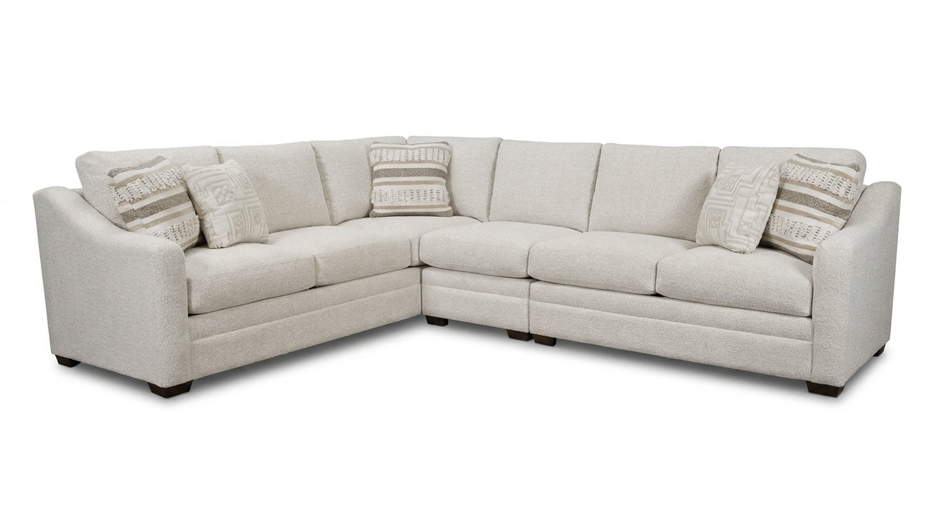Beige sectional sofa with cushions on a white background