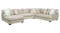 Gray sectional sofa with decorative pillows on a white background
