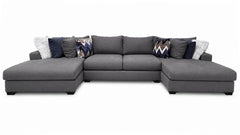 Gray sectional sofa with patterned cushions on a white background