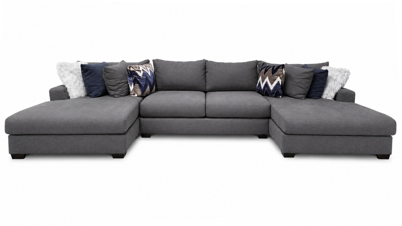 Gray sectional sofa with patterned cushions on a white background