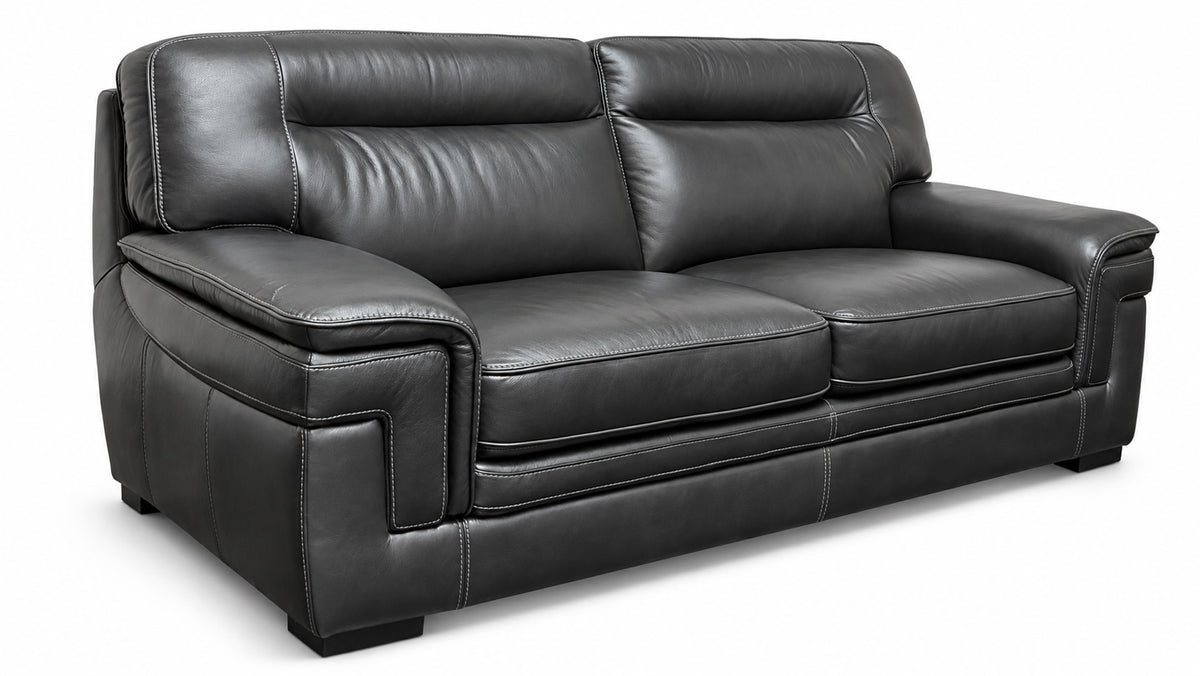 A black leather loveseat sofa with deep channel tufting on the backrest and seat cushions, shown from a three-quarter angle against a white background.
