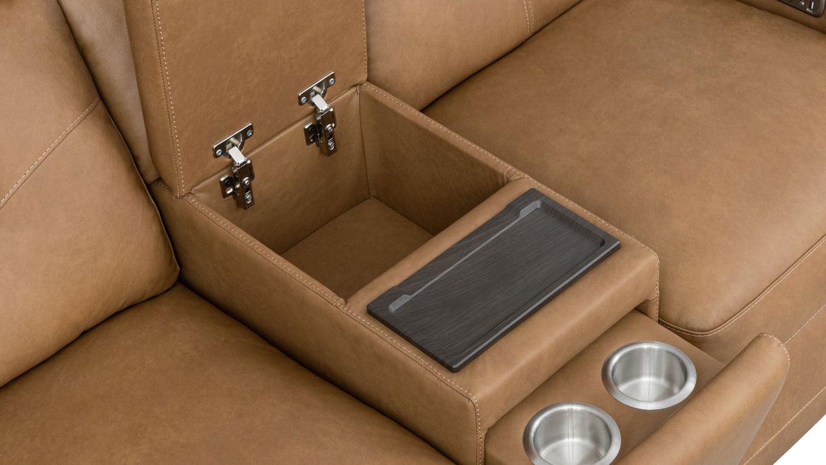 Close-up of a tan leather center console with a lift-up lid revealing storage space, a dark tray insert, and two stainless steel cup holders.
