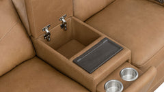 Close-up of a tan leather center console with a lift-up lid revealing storage space, a dark tray insert, and two stainless steel cup holders.