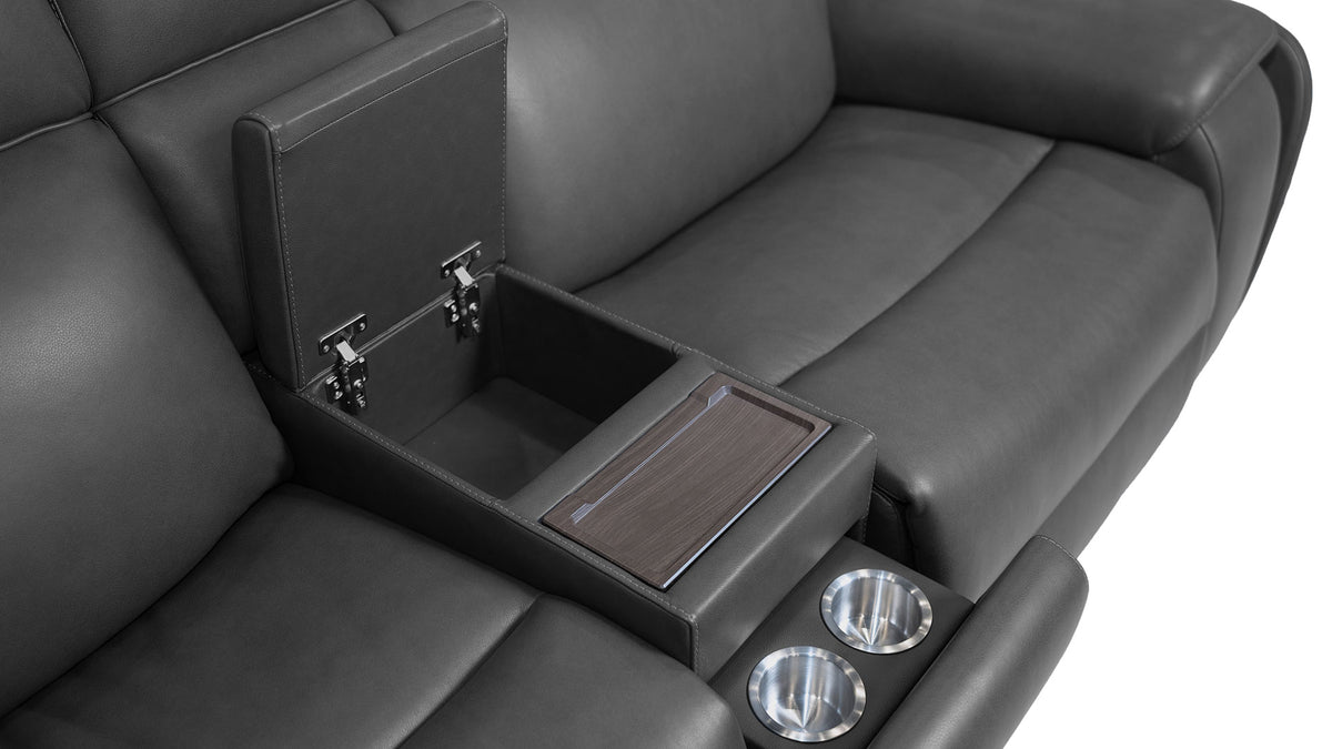 A dark gray leather reclining sofa with an open center armrest console showing a storage compartment and cup holders, photographed on a white background.