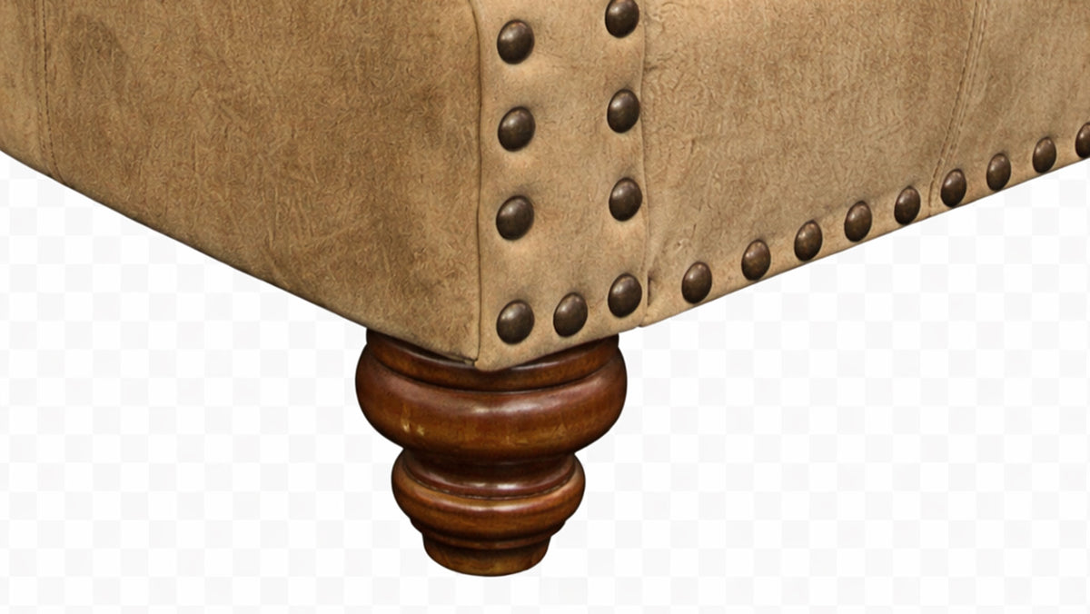 Close-up of a brown upholstered chair with wooden legs on a white background