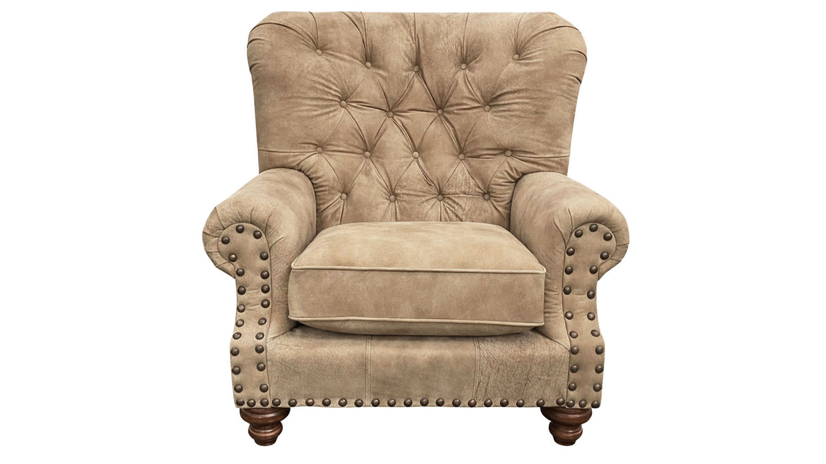 Beige armchair with tufted backrest and nailhead trim on a white background