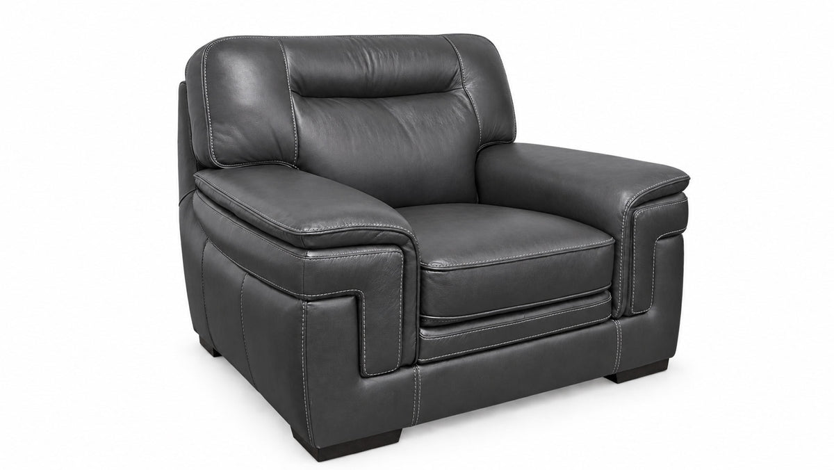 A dark gray leather recliner armchair with a high backrest and padded armrests, shown from a three-quarter angle on a white background.
