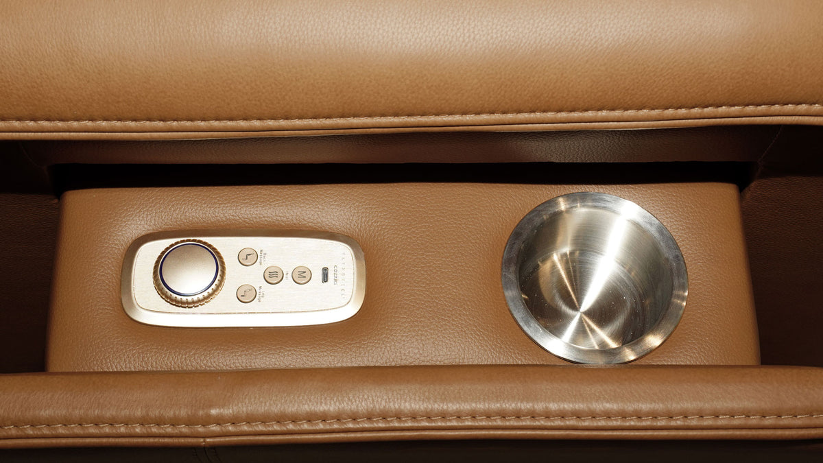 Close-up of a brown leather reclining chair feature, showing a built-in control panel with a rotary dial and buttons on the left and a stainless steel cup holder on the right.