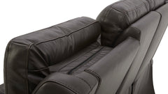 Close-up of a black leather sofa with visible stitching on a white background