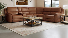 A large brown leather sectional sofa with power reclining features, situated in a room with a modern coffee table and rug.